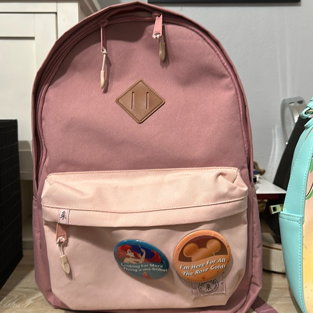 Rose color backpack with Two Disney buttons